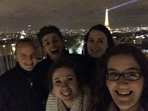 At the top of Paris as the Eiffel Tower glowed behind us